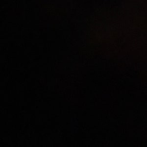 May include: A black background with a subtle grainy texture.