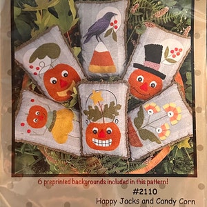 May include: A package featuring a collection of Halloween-themed bowl fillers. The design includes various pumpkin and candy corn-themed pillows with embroidered details. The text "Happy Jacks and Candy Corn" is visible. Finished size is about 4" x 6".