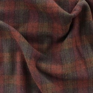 May include: A piece of fabric featuring a dark plaid pattern with intersecting lines in shades of deep red, forest green, and charcoal gray. The textile has a soft, brushed texture with visible fibers and folds that create depth and shadows.
