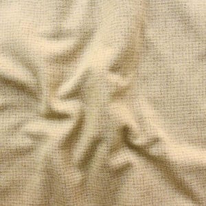 May include: Close-up of a textured fabric in a light beige color. The fabric has a woven appearance with subtle variations in tone, creating a soft, inviting look. The folds and shadows add depth and dimension to the material.