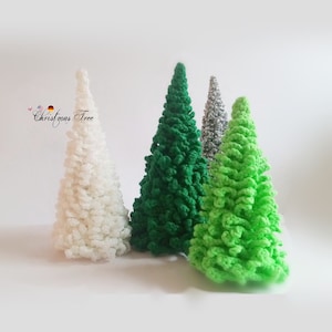 May include: Four handmade crochet Christmas trees in varying shades of green, white, and silver. The trees are cone-shaped with textured, looped yarn, creating a soft, decorative appearance. The text "Christmas Tree" is visible in the image.