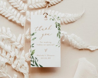 May include: A white thank you tag with green foliage and gold lettering. The tag reads "Thank you for making today so special!" and "Melody's Shower 09.25.XX".