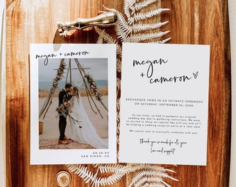 May include: A wooden tray holds wedding stationery, including a photo and a card with the names "Megan + Cameron." A gold wax seal and a fern add decorative elements. The photo shows a couple at a wedding ceremony. The text on the card reads "Exchanged vows in an intimate ceremony."