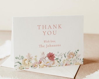 May include: A white thank you card with a floral border and the text "Thank You" in pink. The text "With love, The Johnsons" is also in pink.