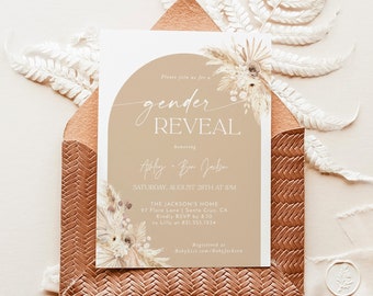 May include: A gender reveal party invitation with a beige background and a watercolor illustration of dried flowers and grasses. The text reads "Please join us for a gender reveal honoring Ashley & Ben Jackson" and includes the date, time, location, and RSVP information.
