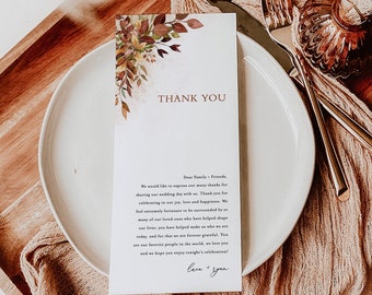 May include: A white card with a thank you message and floral design. The card reads "Thank You" and includes a message expressing gratitude to family and friends for attending the wedding. The card is signed "Love & Yon".