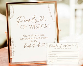 Puede incluir: Una tarjeta de boda imprimible con el texto "Pearls of Wisdom" y un espacio para que los invitados escriban consejos para la novia. La tarjeta está decorada con un diseño de perlas y vides.
