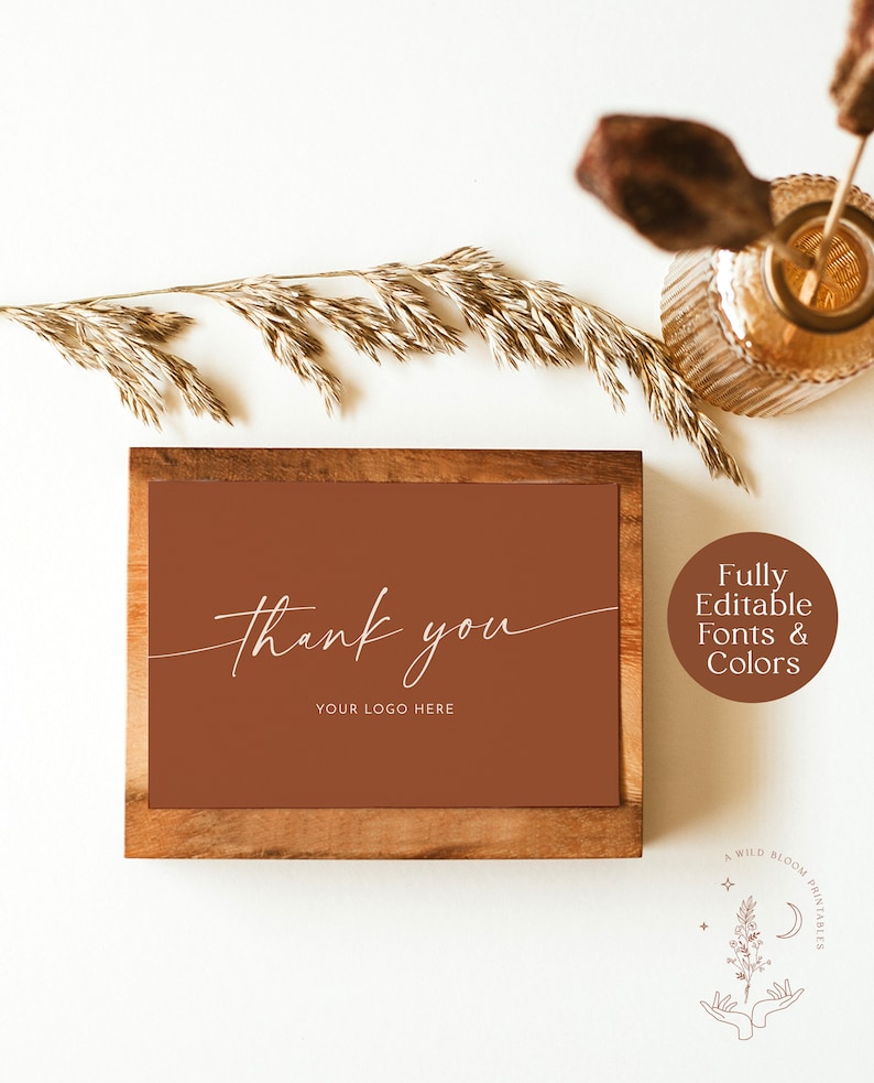 May include: A brown wooden frame with a brown background and white text that says "thank you" and "your logo here". The frame is on a white surface with a vase of dried grass and a wooden stick.
