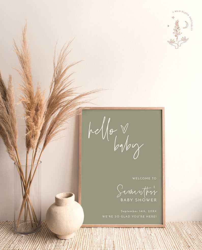 May include: A sage green printable sign with white text that reads "hello baby" and "Welcome to Samanthi's Baby Shower September 14th, 20XX We're so glad you're here!"