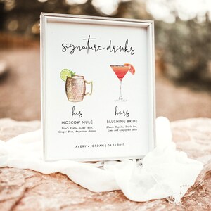 K&ouml;nnte beinhalten: Ein wei&szlig;es Schild mit dem Text "signature drinks" oben. Das Schild listet zwei Getr&auml;nke auf, "his" Moscow Mule und "hers" Blushing Bride, mit den Zutaten f&uuml;r jedes Getr&auml;nk darunter. Das Datum "09.24.2025" und die Namen "AVERY & JORDAN" stehen unten auf dem Schild.