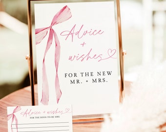 May include: A white card with a pink ribbon and the text "Advice + wishes" for the new Mr. + Mrs.  A smaller card with the text "Advice + wishes" for the soon-to-be Mrs. is below the larger card.