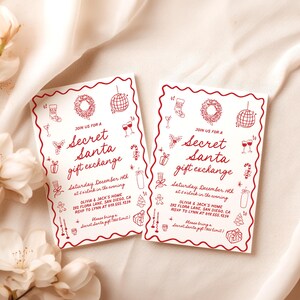 May include: Two rectangular Secret Santa gift exchange invitations with red borders and festive illustrations. The text includes event details: date, time, location, and RSVP information. The invitations are on a cream-colored fabric background.