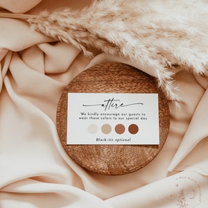 May include: A white card with the word "attire" written in cursive. The card has a message encouraging guests to wear colors in shades of beige, brown, and orange. The card also states "Black-tie optional". The card is sitting on a wooden coaster.