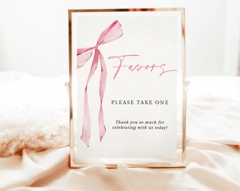 May include: A white sign with a pink watercolor bow and the text "Favors" in cursive. The sign also says "Please take one" and "Thank you so much for celebrating with us today!"