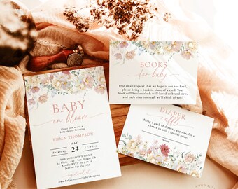 May include: A floral-themed baby shower invitation with a pink and white color scheme. The invitation features the text "Baby in Bloom" and includes details about the event, such as the date, time, and location. The invitation also includes a request for guests to bring a book in place of a card, and a diaper raffle.