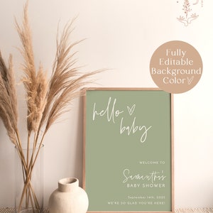 Może przedstawiać: Drukowana tablica na baby shower z zielonym tłem i białym tekstem, kt&oacute;ry brzmi "hello baby". Tablica zawiera r&oacute;wnież imię "Samanthi's", datę "September 14th, 2025" oraz tekst "Witamy na baby shower" i "Cieszymy się, że jesteś!"