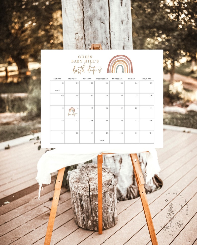 May include: A white printable calendar with a rainbow design and the text "Guess Baby Hill's Birth Date" at the top. The calendar is for June and July and has a small heart icon next to the text.