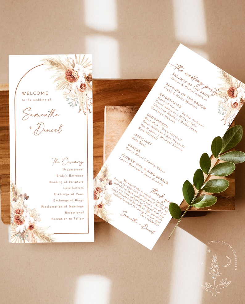May include: A wedding ceremony programme with a floral design featuring dried pampas grass and blush pink flowers. The programme includes the names Samantha and Daniel, the wedding party, and the order of the ceremony.