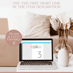 May include: Editable table number template with a pink and white design. The number 3 is displayed in black script font. The text "table" is written in black script font and is enclosed in a pink rectangle with a white border. The text "table 3" is displayed on a laptop screen.