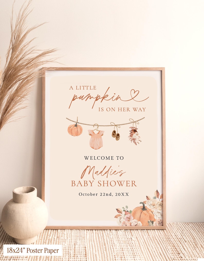 May include: A rectangular framed poster with a cream background featuring the text A LITTLE PUMPKIN IS ON HER WAY, WELCOME TO Maddie's BABY SHOWER, and October 22nd, 20XX. It displays a clothesline with a pumpkin, onesie, shoes, and flowers.