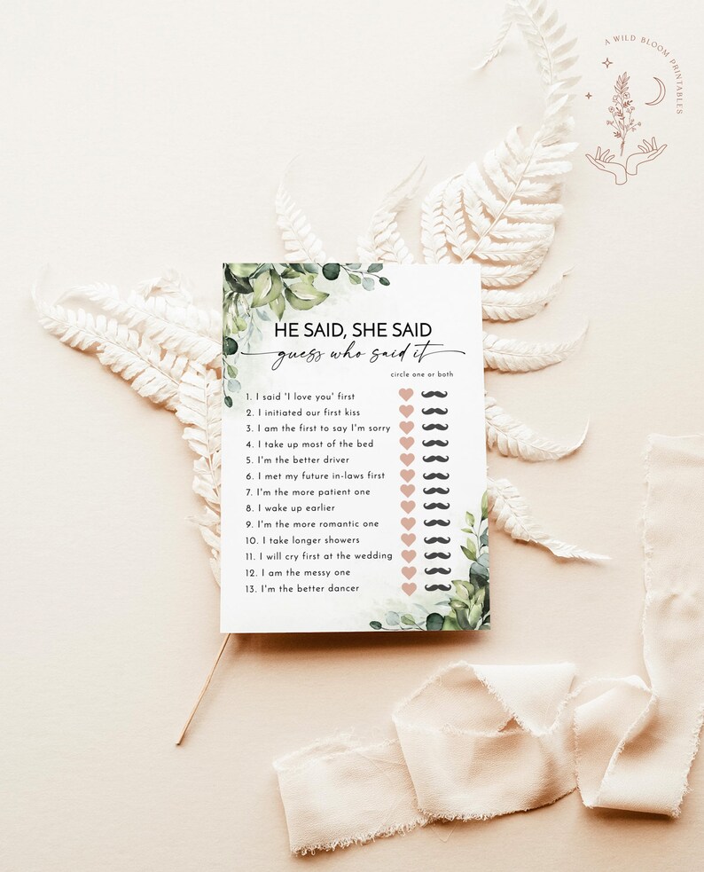 May include: A white card with the text "He Said, She Said guess who said it" surrounded by green foliage. The card has a list of statements with mustache and heart icons for circling. A Wild Bloom Printables logo is in the top right.