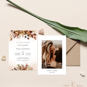 May include: Wedding invitation with fall foliage design. The invitation features the names Luca Sloan and Ryan Anderson, the date September 28th, and the time 4:00 PM. The invitation also includes the location, Galveston Estate, San Diego, California. The invitation is printed on a cream-colored card with a watercolor background.