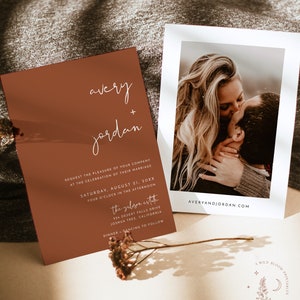 May include: A wedding invitation with a rustic brown background and white text. The invitation reads "avery + jordan" and includes the date, time, and location of the wedding. The invitation also includes the text "the gabizon estate" and "dinner + dancing to follow".