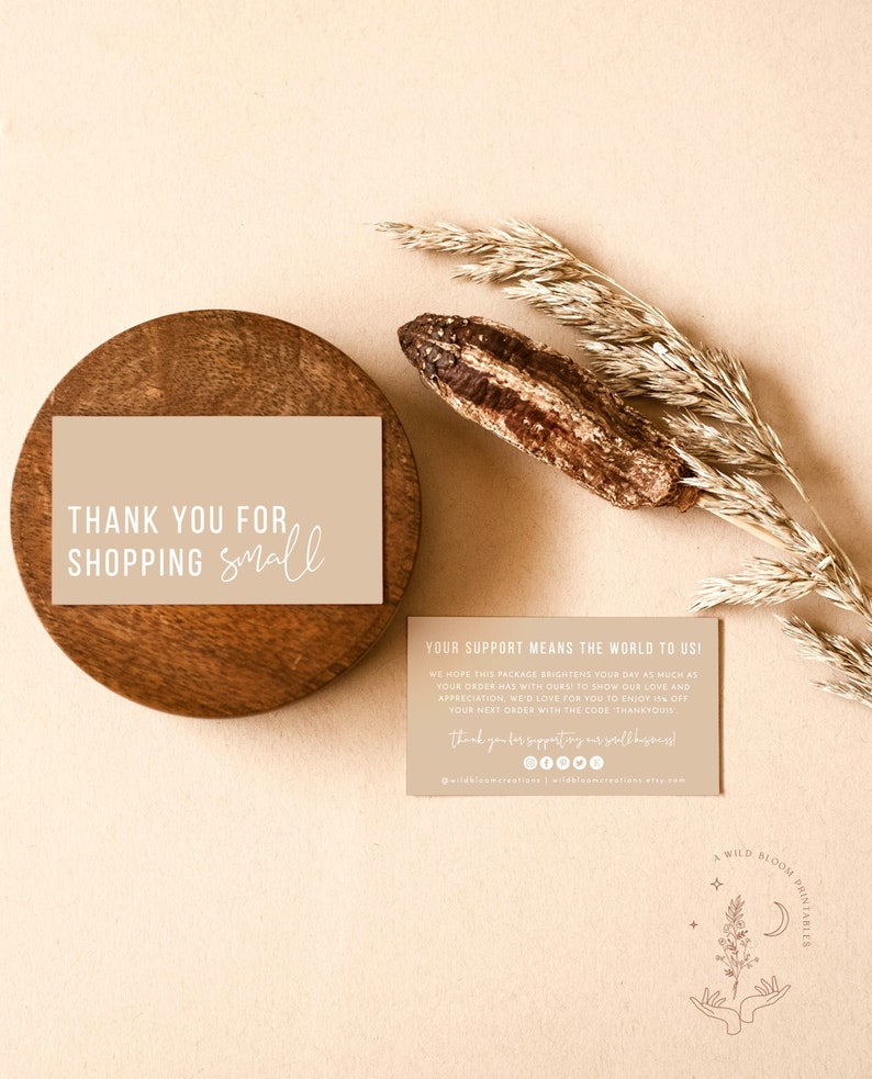 May include: A thank you card with a beige background and white text that reads "Thank you for shopping small". The card is on a wooden coaster. A second card with a beige background and white text reads "Your support means the world to us! We hope this package brightens your day as much as your order was with ours to show our love and appreciation, we'd love for you to enjoy 15% off your next order with the code THANKYOUS. Thank you for supporting our small business!" The card has social media icons and a website address.