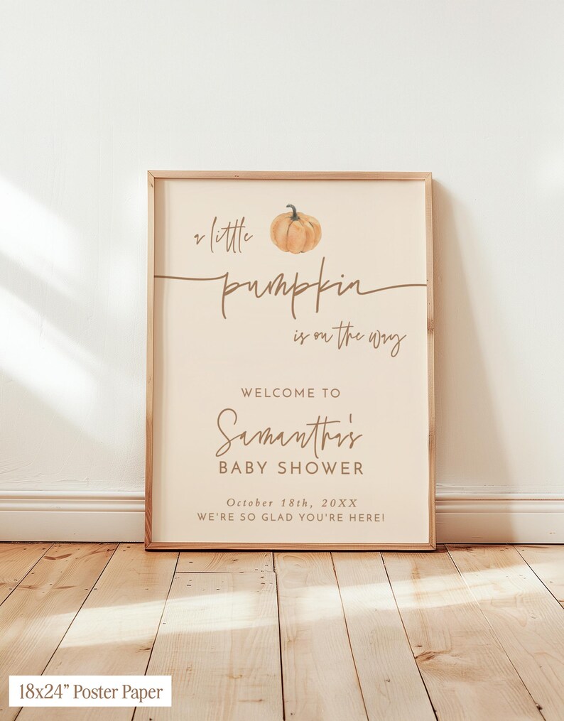 May include: A rectangular poster in a wooden frame featuring a watercolor pumpkin illustration and the text: A little pumpkin is on the way, Welcome to Samantha's Baby Shower, October 18th, 20XX, We're so glad you're here. The poster measures 18x24 inches.