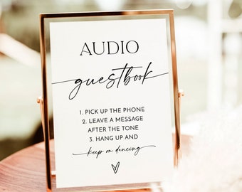 May include: A gold-framed sign with the text "AUDIO guestbook" and instructions for leaving a voice message: "1. PICK UP THE PHONE 2. LEAVE A MESSAGE AFTER THE TONE 3. HANG UP AND keep on dancing"