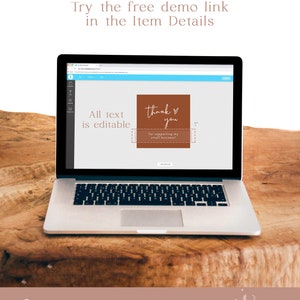 May include: A laptop computer displaying a mockup of a thank you card with the text "thank you for supporting my small business!" in a brown rectangle with a white heart. The text "All text is editable" is visible on the screen. The laptop is on a wooden surface.