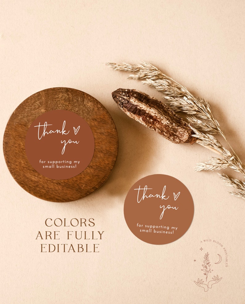 May include: Two round thank you stickers with a brown background and white text. The text on the stickers reads "thank you" with a heart symbol and "for supporting my small business!"  The stickers are on a wooden surface. The text "COLORS ARE FULLY EDITABLE" is below the stickers.