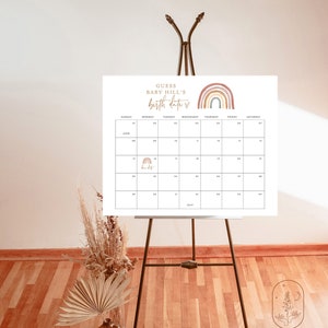 May include: A white printable calendar with a rainbow design and the text "Guess Baby Hill's Birth Date" at the top. The calendar is set up for June 2023 and has a small rainbow icon on the 14th.