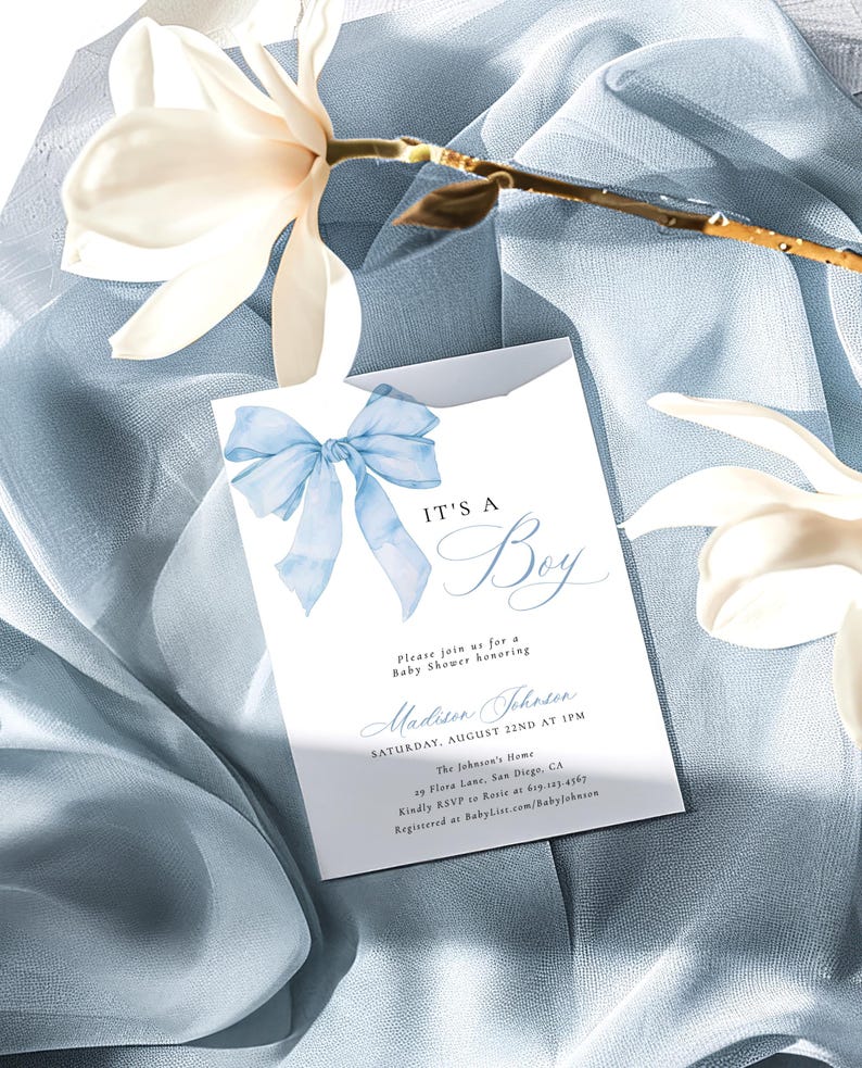May include: A baby shower invitation with a blue bow and the text "It's a Boy" in a cursive font. The invitation includes the date, time, and location of the shower, as well as the name of the guest of honor, Madison Johnson.