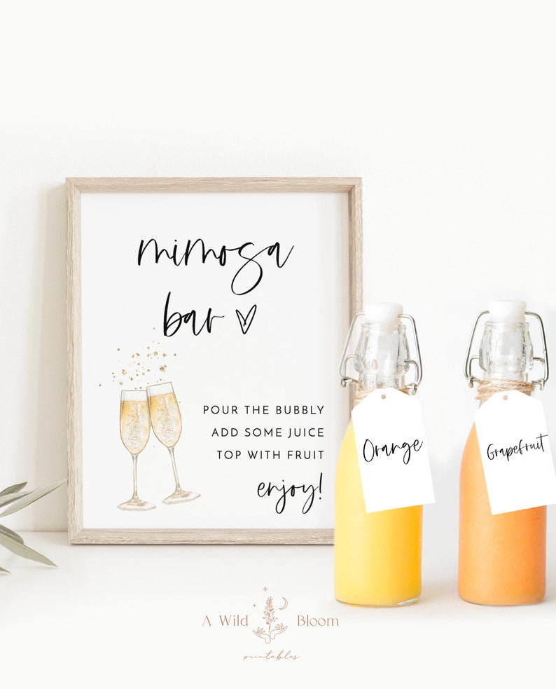 May include: A printable sign that says "mimosa bar" with a heart symbol. The sign is framed in a light wood frame. There are two glass bottles with orange juice, one labeled "Orange" and the other labeled "Grapefruit".