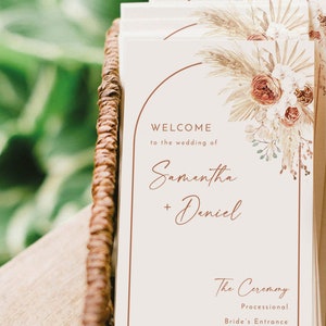 May include: A wedding ceremony programme with a beige background and a floral illustration. The text reads "Welcome to the wedding of Samantha + Daniel" and lists the order of the ceremony: Processional, Bride's Entrance, Reading of Scripture, Love Letters.