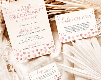 May include: A baby shower invitation set featuring three white cards with pink and brown watercolour heart illustrations. The text includes A little sweetheart is on her way, Books for baby, and Diaper raffle, with event details and registry information.