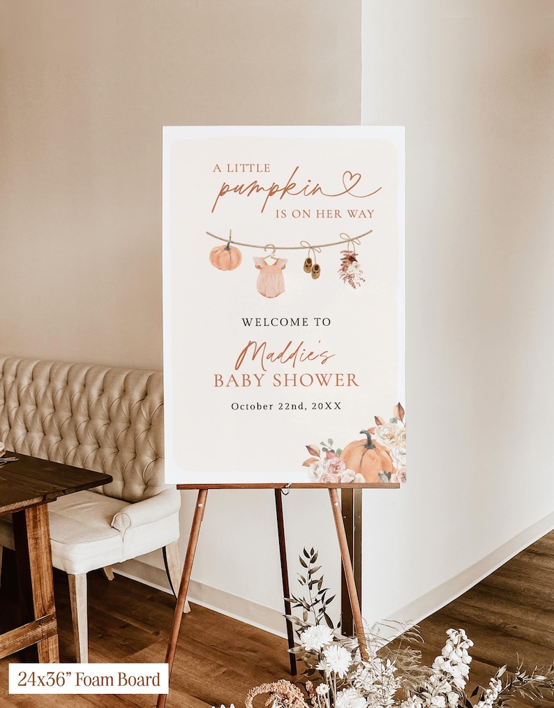 May include: A 24x36 inch foam board sign for a baby shower with the text A LITTLE pumpkin IS ON HER WAY, WELCOME TO Maddie's BABY SHOWER, and October 22nd, 20XX. The design features a clothesline with a pumpkin, onesie, shoes, and flowers.