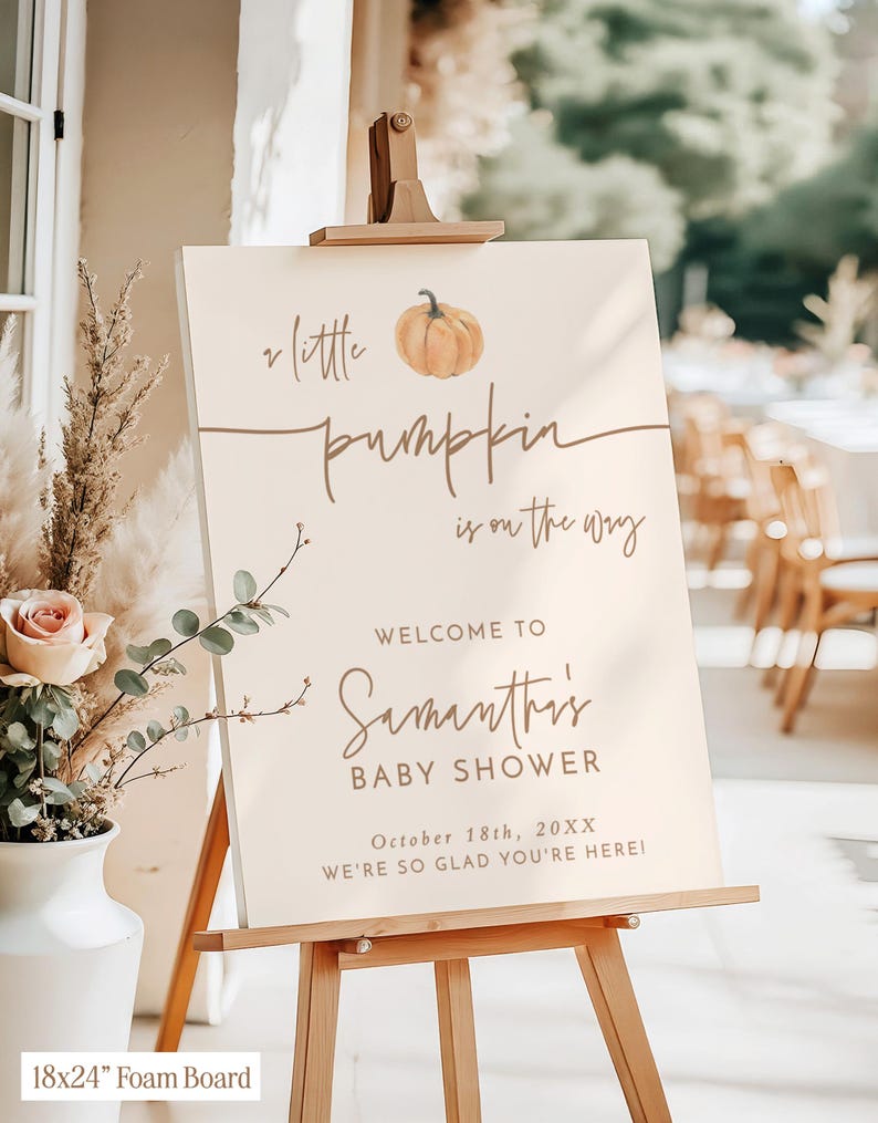May include: A rectangular 18x24 inch foam board sign on a wooden easel. The sign is cream-colored with brown text reading: A little pumpkin is on the way, WELCOME TO Samantha's BABY SHOWER, October 18th, 20XX, WE'RE SO GLAD YOU'RE HERE!