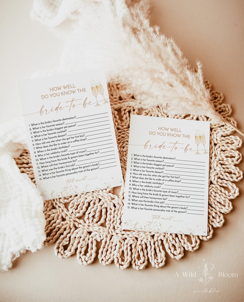 May include: Two printable game cards with a gold glitter background and a watercolor illustration of champagne flutes. The cards are titled "How Well Do You Know The Bride-To-Be?" and feature a list of questions about the bride.