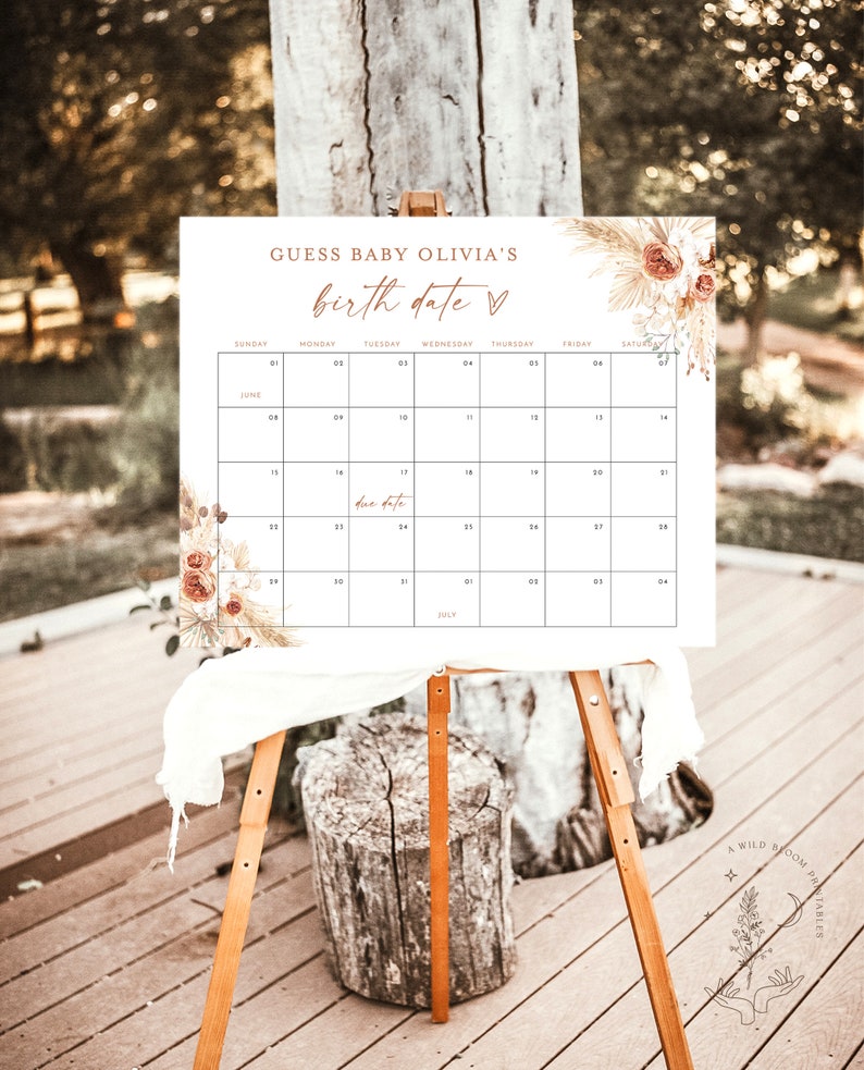 Puede incluir: Un calendario imprimible blanco con un dise&ntilde;o floral y el texto "Adivina la fecha de nacimiento de la beb&eacute; Olivia" en texto marr&oacute;n. El calendario es para junio y julio y tiene una fecha de vencimiento marcada el 17 de junio.