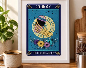 May include: A framed wall art print featuring a tarot card design with a blue background, a skeleton hand holding a coffee cup, a yellow zodiac wheel, and colorful flowers. The text at the bottom reads THE COFFEE ADDICT in white.