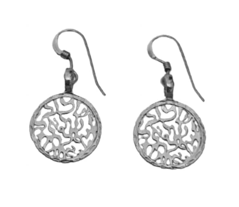 May include: A pair of silver earrings with a circular design featuring a delicate filigree pattern. The earrings have a simple hook closure.