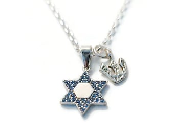May include: A silver necklace with a blue and white Star of David pendant and a small silver charm.