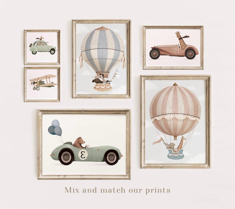 May include: Set of five framed prints featuring whimsical illustrations of hot air balloons, airplanes, and cars. The prints are in a light brown frame with a white mat. The illustrations feature animals like giraffes, bears, and elephants.