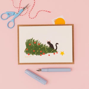 Naughty black cat with knocked over Christmas tree- Christmas greetings card