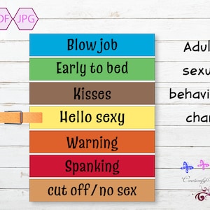 May include: A colorful adult sexual behavior chart with phrases like "Blow job," "Early to bed," and "Kisses." The chart includes a wooden clothespin and the words "Adult sexual behavior chart."