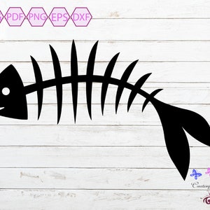 May include: Black silhouette of a fish skeleton with a single white circle for an eye. The skeleton is on a white wood background.