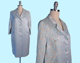May include: A light blue and silver paisley patterned coat with a button closure and pockets.