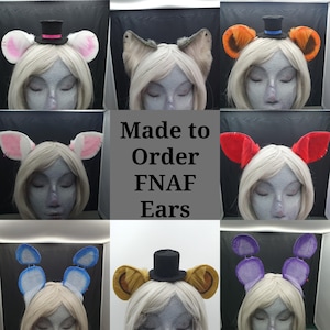 May include: A collage of various FNAF-themed ears, each attached to a wig-wearing mannequin head. The ears come in different colors, including pink, orange, red, blue, and purple, and some are adorned with miniature top hats. The text "Made to Order FNAF Ears" is displayed.